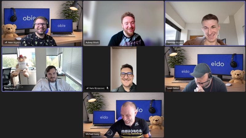 Seven of the Eido team smiling on a video call.