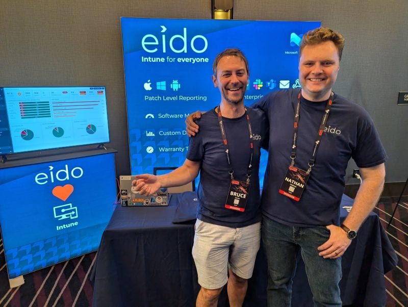 Two of the Eido team in front of the Eido stand at the Midwest Management Summit.