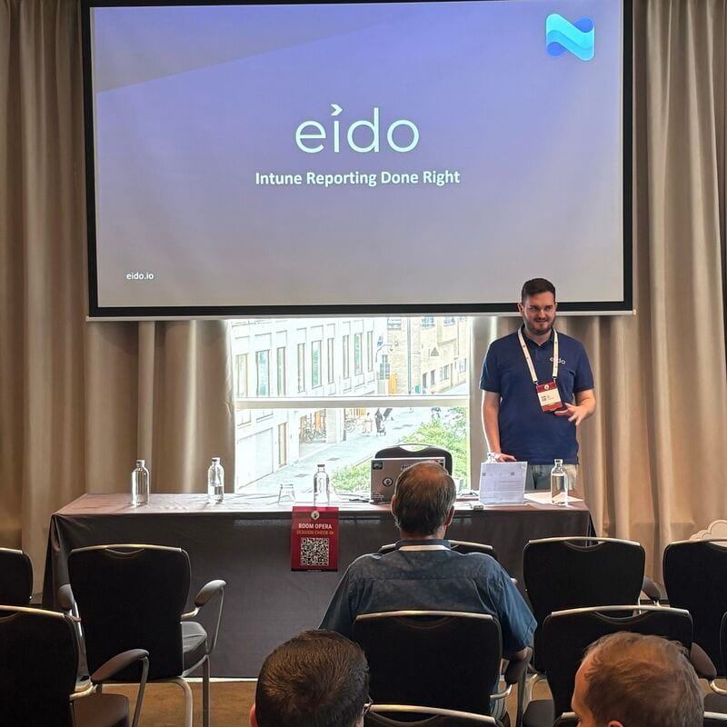 Sean Patten presenting at Workplace Ninjas Belgium in front of a slide reading Eido: Intune reporting done right.